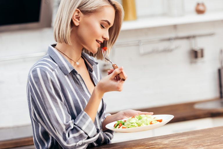 woman mindfully eating a salad