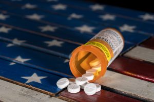 United states of opioids: oxycodone opioid tablets on American flag