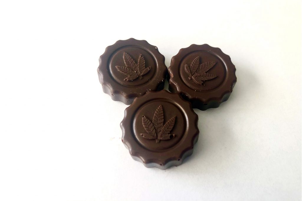 cannabis infused chocolate medallions on white background